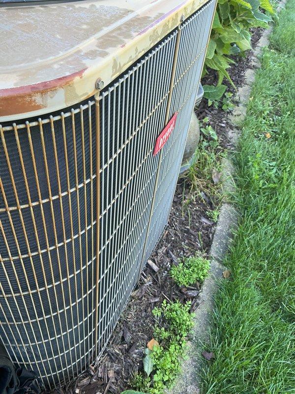 Completed scheduled AC tune-up on Bryant outdoor condensing unit. Performed comprehensive maintenance inspection including cleaning condenser coils, checking refrigerant levels, testing electrical connections, and verifying proper airflow through the fan assembly. Unit operational with normal wear consistent with age, including minor rust staining on top panel and weathering on exterior surfaces.