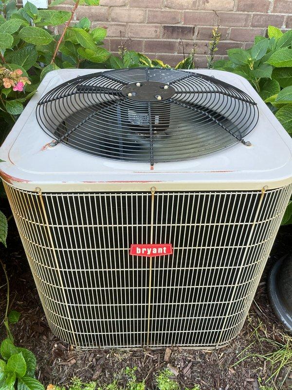 Completed scheduled AC tune-up on Bryant outdoor condensing unit. Performed comprehensive maintenance inspection including cleaning condenser coils, checking refrigerant levels, testing electrical connections, and verifying proper airflow through the fan assembly. Unit operational with normal wear consistent with age, including minor rust staining on top panel and weathering on exterior surfaces.