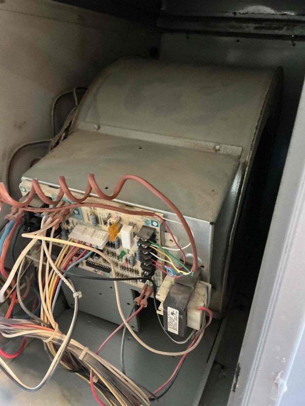 Completed gas furnace tune-up and preventative maintenance inspection on residential HVAC system. Accessed interior cabinet, inspected electrical components including control board, wiring connections, and transformer assembly. Verified proper operation of all electrical connections and terminal blocks. Inspected refrigerant lines and blower compartment, noting system age and general wear consistent with older equipment. All components functioning within normal parameters at time of service.