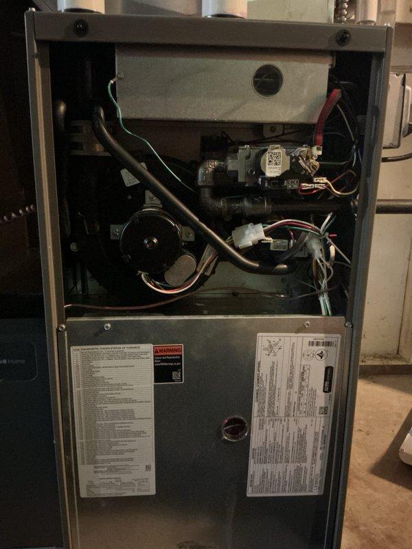 Completed comprehensive multi-system tune-up service on both air conditioning and gas furnace units. Performed thorough inspection of furnace interior components including blower motor assembly, gas valve, electrical connections, and control modules; verified all wiring harnesses and safety switches operational. Documented equipment condition with interior cabinet photography showing all mechanical and electrical components in functional status with normal wear patterns.