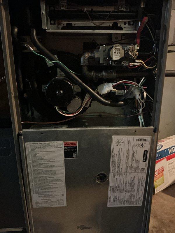 Completed comprehensive multi-system tune-up service on both air conditioning and gas furnace units. Performed thorough inspection of furnace interior components including blower motor assembly, gas valve, electrical connections, and control modules; verified all wiring harnesses and safety switches operational. Documented equipment condition with interior cabinet photography showing all mechanical and electrical components in functional status with normal wear patterns.