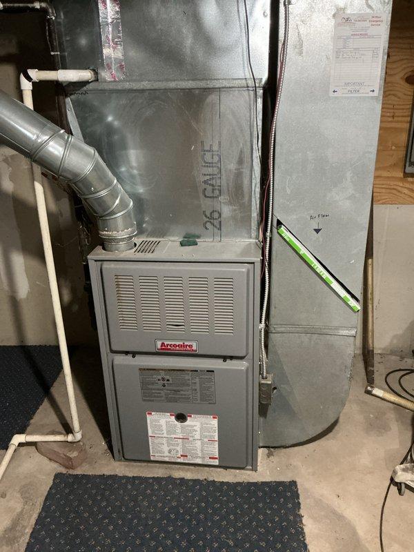 Completed comprehensive tune-up service on four-piece HVAC system consisting of two air conditioning units and two gas furnaces, including one Arcoaire furnace located in basement mechanical room. Performed standard maintenance procedures on all equipment, inspected outdoor condenser units, verified proper operation of all components, and presented membership program options to customer.