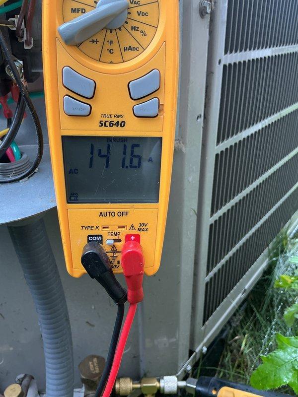 Completed comprehensive tune-up and preventative maintenance on multi-zone HVAC system including air conditioning and gas furnace units. Performed electrical diagnostics using digital multimeter, measuring inrush current at 747.6 amps and verifying proper voltage levels. Inspected condenser unit with access panel open, tested capacitor functionality, examined all electrical connections and wiring harnesses, and attached refrigerant gauges to verify system pressures and refrigerant charge levels. Membership renewal processed and future maintenance appointment scheduled.