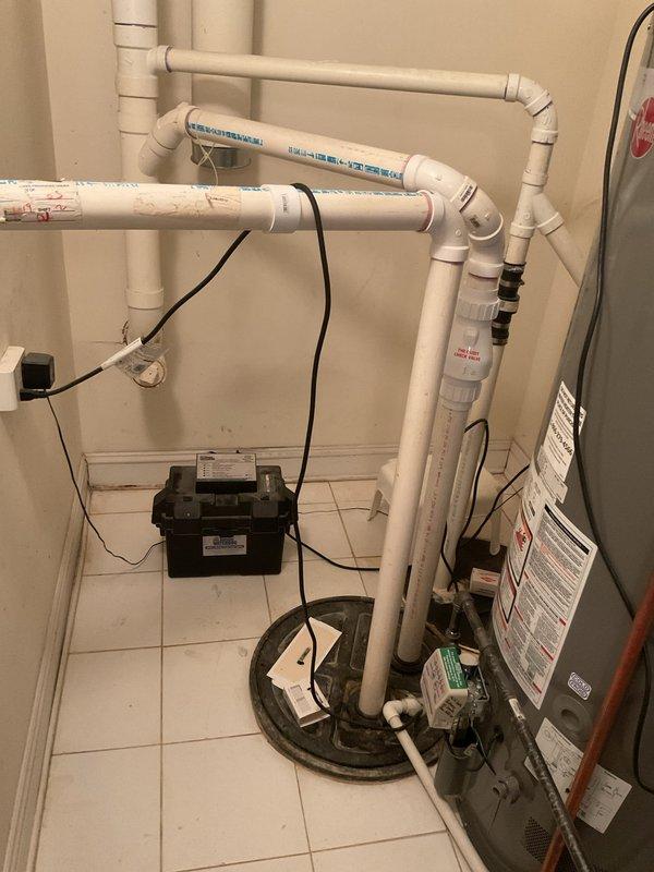 Completed installation of a sump pump system with battery backup in the utility area. Installed new PVC discharge piping with appropriate connections and a dedicated control unit with LED indicators. System includes a Storm backup component for flood prevention during power outages.