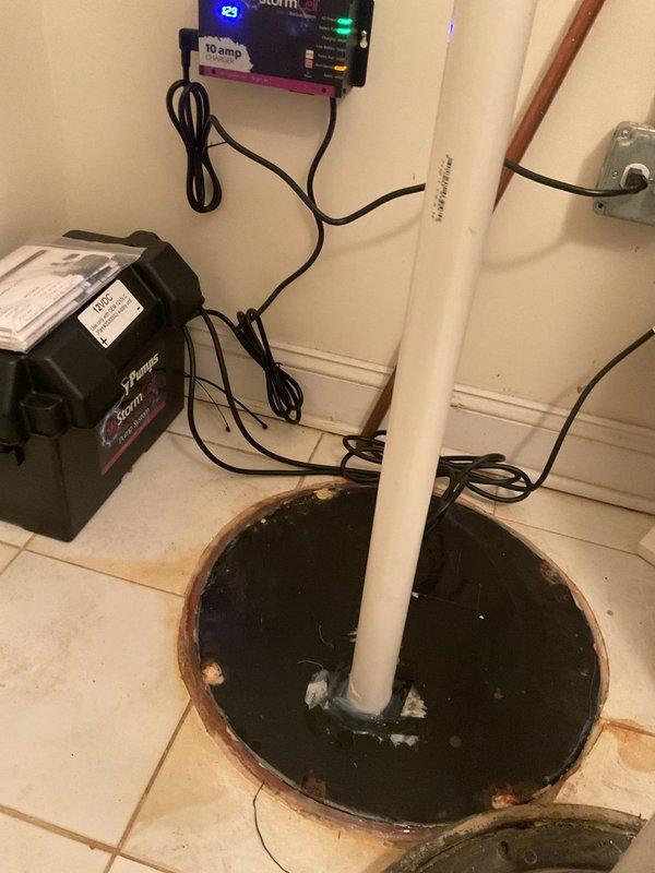 Completed installation of a sump pump system with battery backup in the utility area. Installed new PVC discharge piping with appropriate connections and a dedicated control unit with LED indicators. System includes a Storm backup component for flood prevention during power outages.