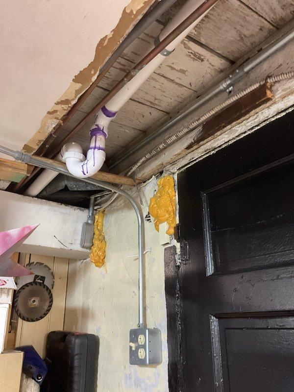 Cleared toilet clog and conducted thorough inspection of plumbing system. Documented significant issues in utility room including improper pipe configurations, deteriorating ceiling materials, and visible purple primer at PVC joints indicating previous amateur repairs. Recommended complete re-piping of water and drain lines with proper professional installation to address current issues and prevent future problems.