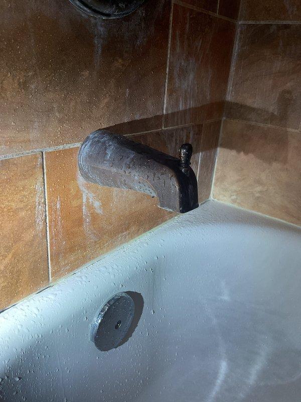 Performed inspection of toilet system experiencing suctioning noises and tissue paper backflow during flushing. Examined plumbing connections and gasket integrity to identify cause of improper drainage. Provided customer with assessment of jacuzzi-to-standard bathtub conversion options, noting significant corrosion and mineral buildup on existing bathroom fixtures that would benefit from replacement.