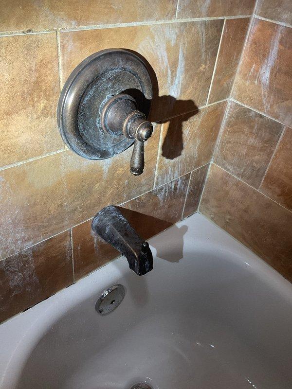 Performed inspection of toilet system experiencing suctioning noises and tissue paper backflow during flushing. Examined plumbing connections and gasket integrity to identify cause of improper drainage. Provided customer with assessment of jacuzzi-to-standard bathtub conversion options, noting significant corrosion and mineral buildup on existing bathroom fixtures that would benefit from replacement.