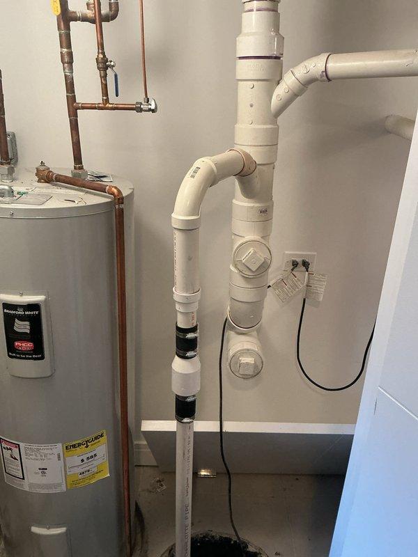 Performed camera inspection of sewer line that previous company was unable to complete successfully. Examined water heater installation system with copper and PVC piping components. Visual inspection revealed properly installed plumbing with no visible damage, leaks, or deterioration to any components.