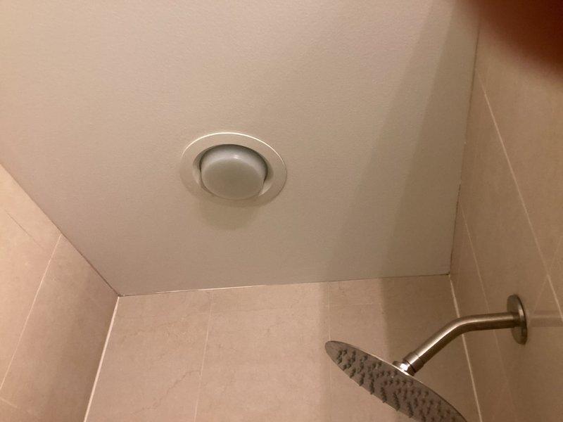 Responded to a water leak issue originating from the unit above. Conducted thorough inspection of the affected bathroom ceiling area showing signs of water infiltration. Located the source of the leak in the upstairs unit's shower drain assembly, which exhibited significant mineral buildup and deterioration around the drain seal. Repaired the faulty drain connection and verified proper drainage function with no further leakage.