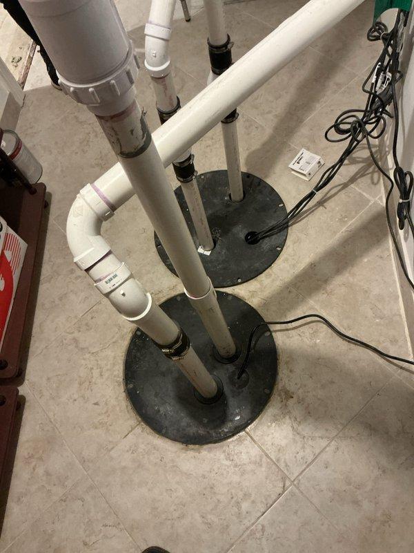 Performed complimentary camera inspection of drainage system as scheduled, requiring removal and resealing of ejector pit cover. Inspection revealed signs of corrosion and mineral deposits inside the plumbing infrastructure, with particular attention to the cylindrical metal components showing oxidation around connection ports.