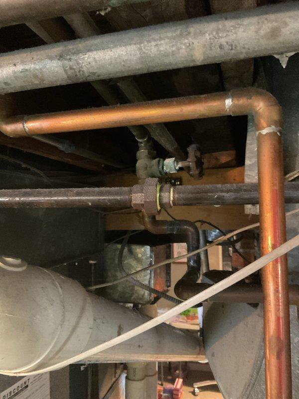 Responded to customer complaint of tankless water heater leaking from base with no hot water output. Upon inspection, found water leakage at base of unit mounted on brick wall. Diagnostic assessment revealed internal component failure affecting water containment system. Opened unit to examine circuit boards, wiring, and plumbing connections. Traced issue to compromised seal at copper pipe junction. Repaired connection and tested system functionality to confirm proper operation and elimination of leak.