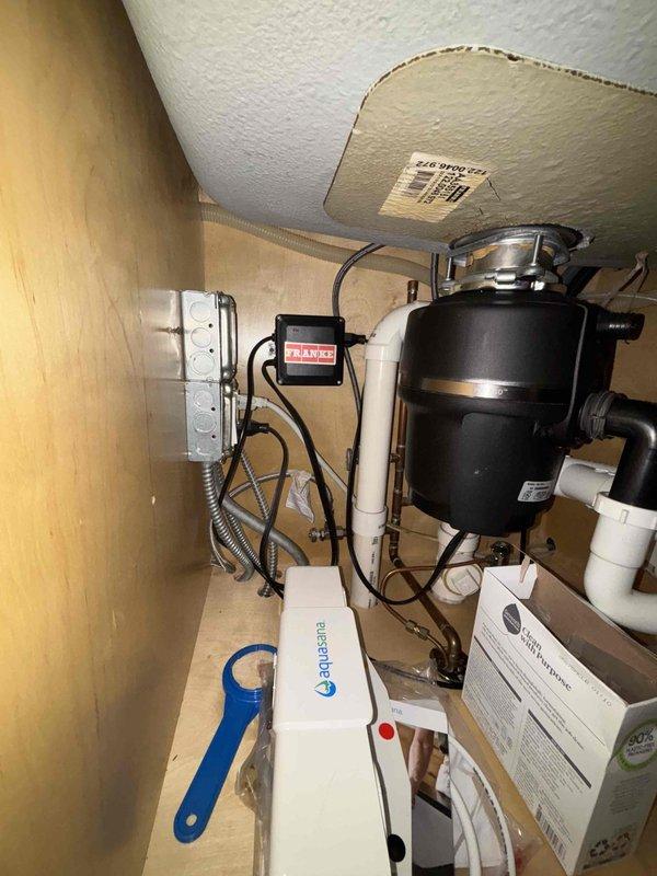 Successfully installed an Aquasana under-sink water filtration system and InSinkErator air switch button in customer's kitchen. Worked in confined cabinet space with existing plumbing configuration, properly connecting the filtration system and ensuring all components were securely mounted and functional.
