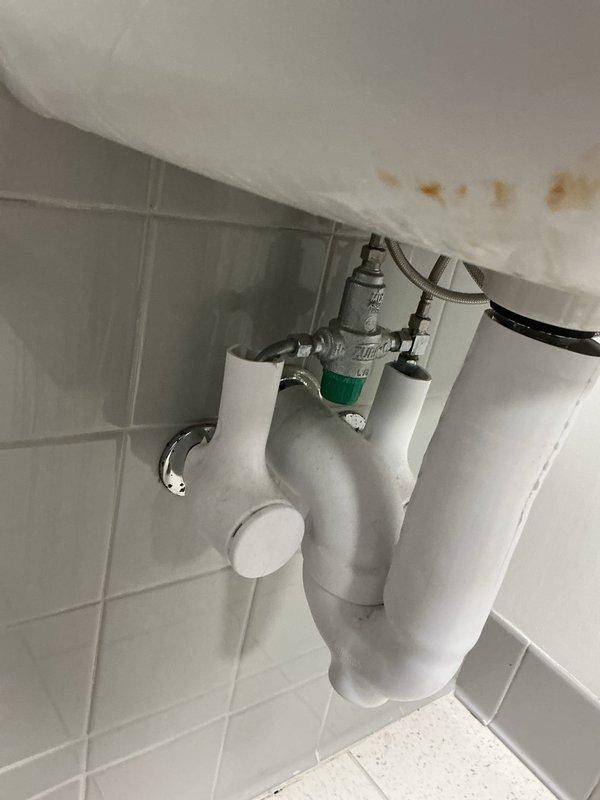 Responded to service request at preschool classroom to replace mixer valve for sink. Inspection revealed water damage/mineral buildup under sink with evidence of leakage around the P-trap assembly. Successfully installed new automatic sensor tap with chrome finish, replacing the defective mixer valve as requested by customer contact Pam.