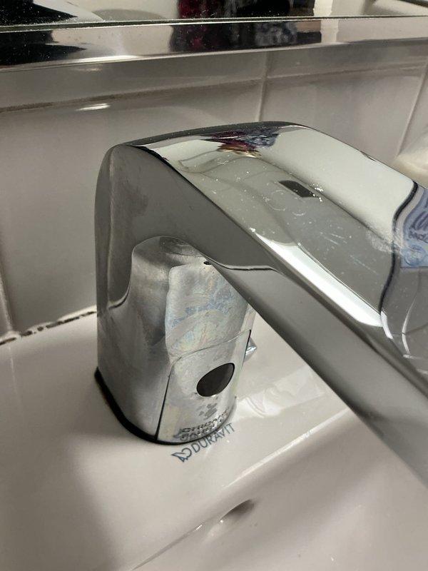 Responded to service request at preschool classroom to replace mixer valve for sink. Inspection revealed water damage/mineral buildup under sink with evidence of leakage around the P-trap assembly. Successfully installed new automatic sensor tap with chrome finish, replacing the defective mixer valve as requested by customer contact Pam.