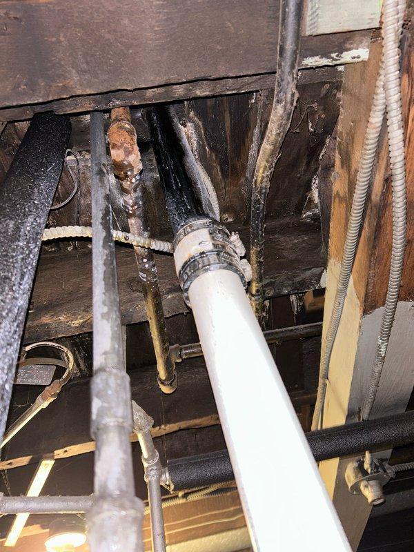 Responded to kitchen sink leak issue causing water damage in basement. Inspection revealed deteriorated PVC drain pipe with failing black coupling fittings. Replaced damaged section of drain pipe and couplings, ensuring proper water-tight connections. Confirmed extensive water damage to wooden joists and recommended customer consult with a remediation specialist regarding the structural water damage.