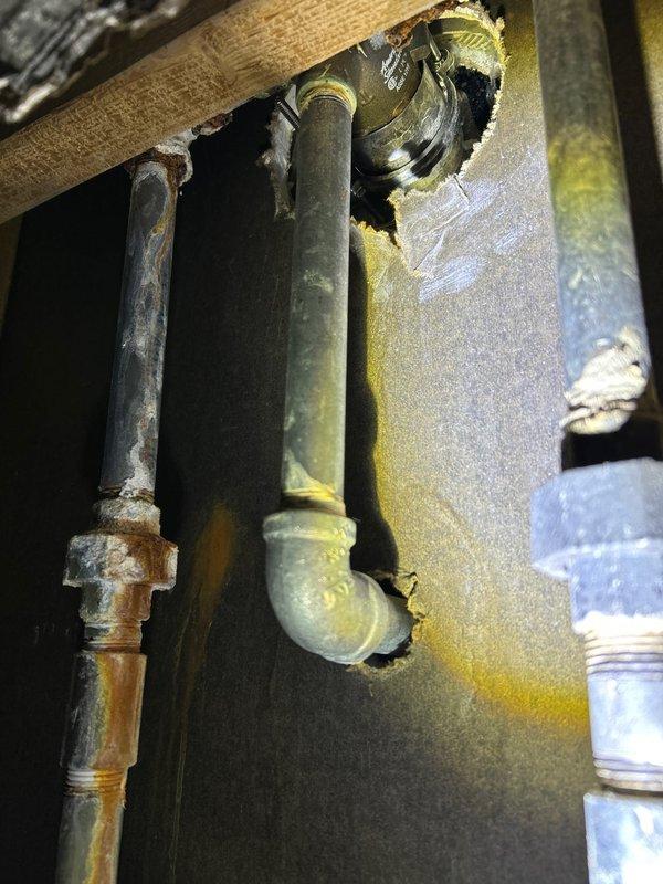 Responded to client complaint about insufficient hot water temperature in shower. Accessed plumbing through wall cavity to inspect the shower valve and water supply lines. Identified oxidation and aging on copper pipes with brass fittings that were restricting proper water flow. Adjusted mixing valve to increase hot water flow capacity, ensuring shower now reaches appropriate temperature.