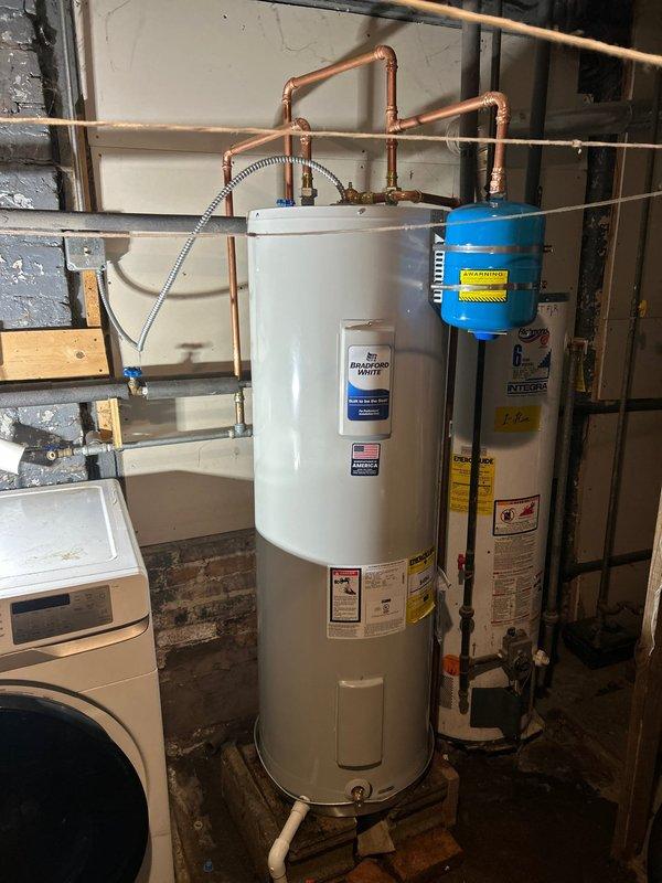 Installed new water heater system with expansion tank and connected all necessary copper supply lines to existing plumbing. Positioned drain pan beneath unit for leak protection and verified proper installation of temperature/pressure relief valve and drainage components per code requirements. System was tested and confirmed operational.