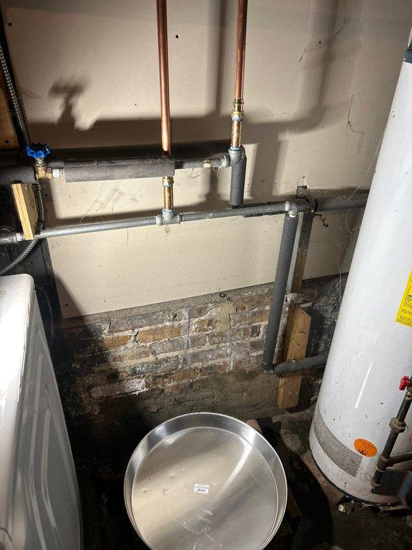 Installed new water heater system with expansion tank and connected all necessary copper supply lines to existing plumbing. Positioned drain pan beneath unit for leak protection and verified proper installation of temperature/pressure relief valve and drainage components per code requirements. System was tested and confirmed operational.