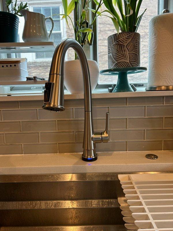 Successfully installed new touch-sensitive kitchen faucet with pull-down spray head functionality. Connected all supply lines and verified proper operation of the touch sensor and LED indicator. Ensured compatibility with existing plumbing system including KitchenAid garbage disposal without any leaks or issues.