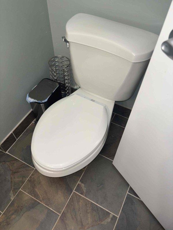 Responded to service call regarding persistent toilet tank dripping noise. Inspection revealed significant mineral deposits and discoloration inside tank affecting proper valve function. Cleaned flush valve assembly, replaced worn components, and adjusted water level to eliminate dripping issue.