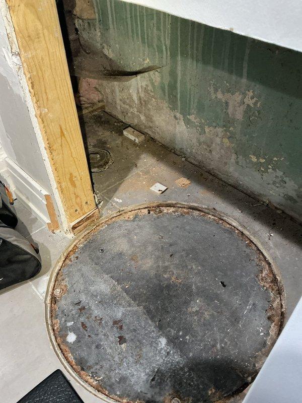 Conducted on-site assessment for flood control system installation. Inspected existing floor drain with rusted metal rim that shows signs of previous water damage, as indicated by deteriorated wall surfaces and peeling paint in the corner area. Evaluated space for proper equipment placement and discussed installation options with customer.