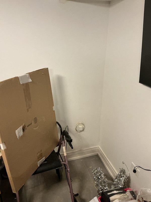 Conducted on-site assessment for flood control system installation. Inspected existing floor drain with rusted metal rim that shows signs of previous water damage, as indicated by deteriorated wall surfaces and peeling paint in the corner area. Evaluated space for proper equipment placement and discussed installation options with customer.