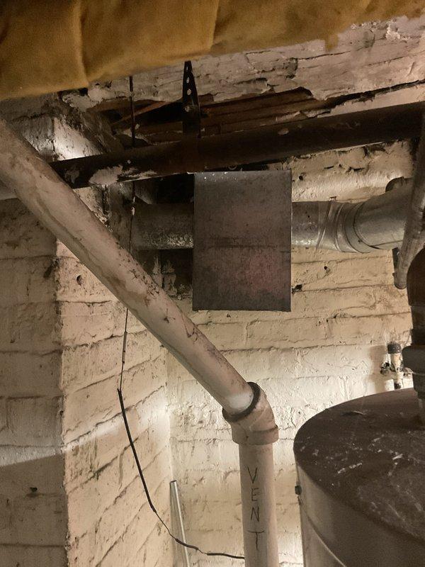 Conducted inspection of a 10-year-old water heater serving a 3-unit building. Identified minimal hot water supply issue in tank system installed June 2017. Observed aging infrastructure including deteriorated insulation on copper pipes and compromised ventilation system. Recommended replacement with appropriately sized unit to restore adequate hot water capacity for multi-unit requirements.