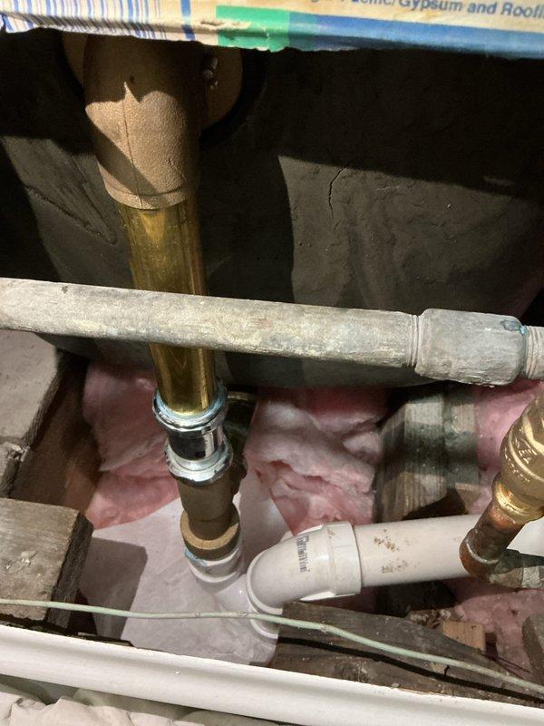 Resolved shower/tub drainage issue by removing broken drain stopper that was stuck in closed position. Accessed plumbing through wall access point to inspect and repair the antiquated spring mechanism. Replaced complete drain open/close assembly with new components, ensuring proper functionality and water drainage.