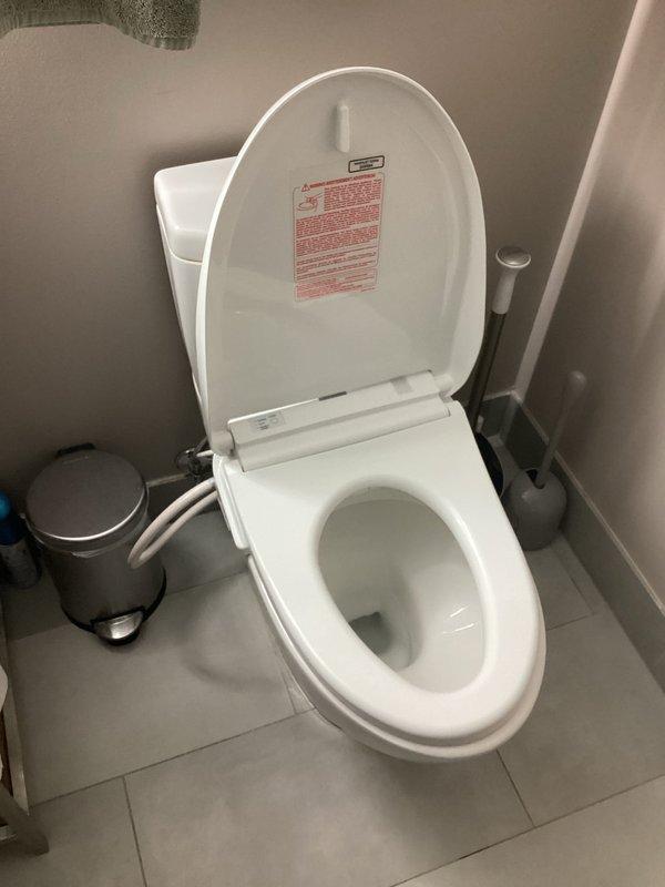 Conducted water leak investigation in bathroom, focusing on toilet area. Performed visual inspection of toilet components and surrounding fixtures. No active leaks identified during inspection; toilet appears to be functioning properly with no signs of water damage around base or supply line. Photos documented for reference.