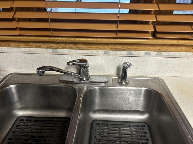 Installed new customer-supplied toilet in bathroom according to Gold Plan specifications. Additionally, replaced kitchen faucet with company-supplied model, ensuring proper connection to existing plumbing system. Both installations completed successfully with operational testing performed to verify proper function and absence of leaks.