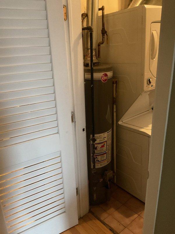 Inspected 30-gallon Rheem water heater in utility closet for replacement estimate. Unit appears functional but at end of service life based on age. Also noted loose kitchen faucet requiring adjustment. Recommendations provided for appropriate replacement options considering existing space constraints and current plumbing configuration.