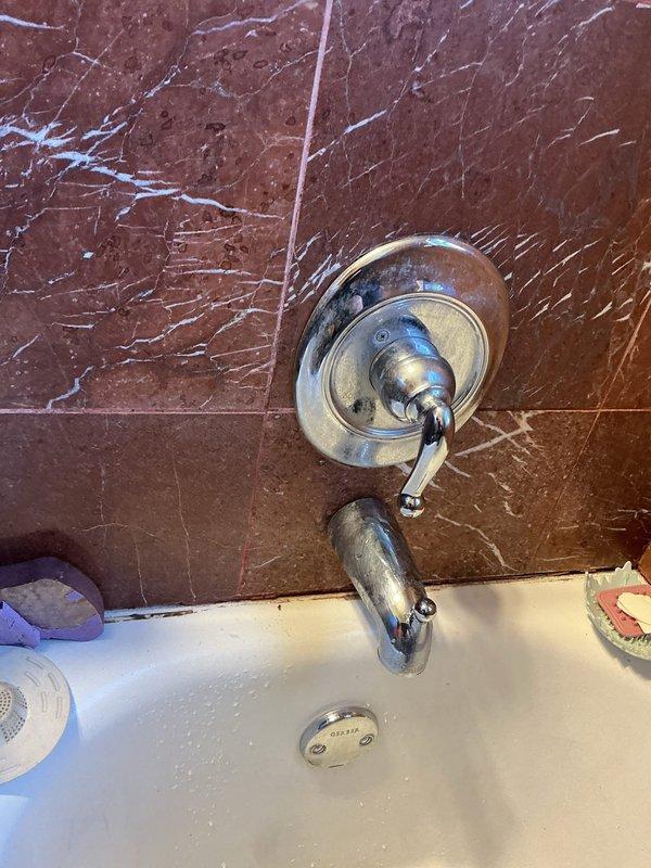 Performed scheduled building water shutdown from 8-12pm to address plumbing issues. Inspected bathroom fixtures including corroded tub/shower faucet and spout showing significant wear. Also examined toilet tank with severe mineral deposits and discoloration requiring attention. Work sold by Brian.