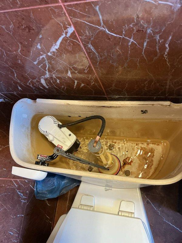 Performed scheduled building water shutdown from 8-12pm to address plumbing issues. Inspected bathroom fixtures including corroded tub/shower faucet and spout showing significant wear. Also examined toilet tank with severe mineral deposits and discoloration requiring attention. Work sold by Brian.
