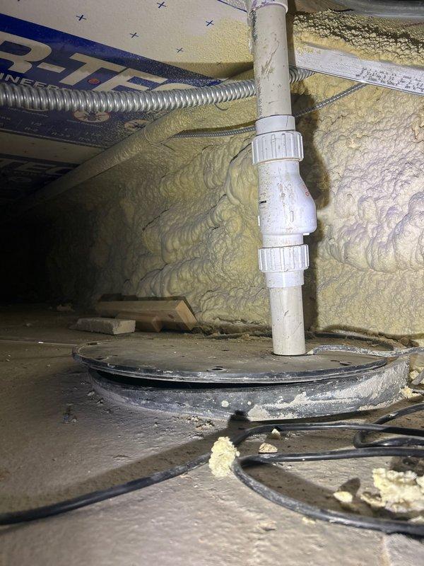 Inspected non-functioning sump pump in crawl space which was producing buzzing noise without pumping action. Examination revealed clogged discharge pipe and worn impeller assembly requiring replacement. Installed new sump pump with upgraded check valve and verified proper water evacuation through PVC discharge piping.