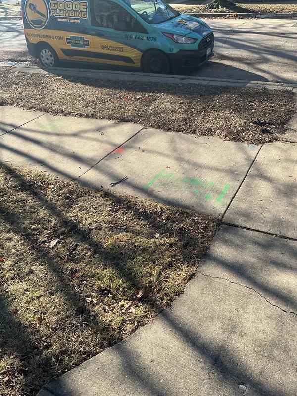 Responded to customer's service request regarding a slow sewer main line at residential property. Inspected bathroom shower which showed significant black mold growth radiating from the drain in a starburst pattern, indicating potential drainage issues. Service vehicle was properly positioned and utility areas were marked with spray paint prior to assessment of the plumbing system.
