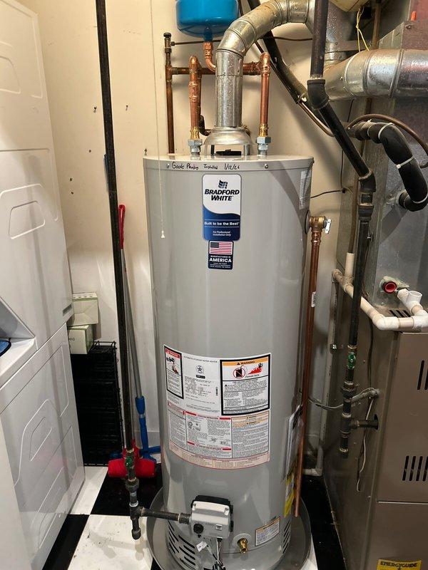 Responded to emergency service call for active water heater leak. Diagnosed a failing Rheem water heater unit with corroded copper pipe connections. Replaced defective unit with new Bradford White water heater, installed blue expansion tank, and replaced deteriorated pipe sections. All connections were pressure tested and system was restored to full operation with no leaks detected.