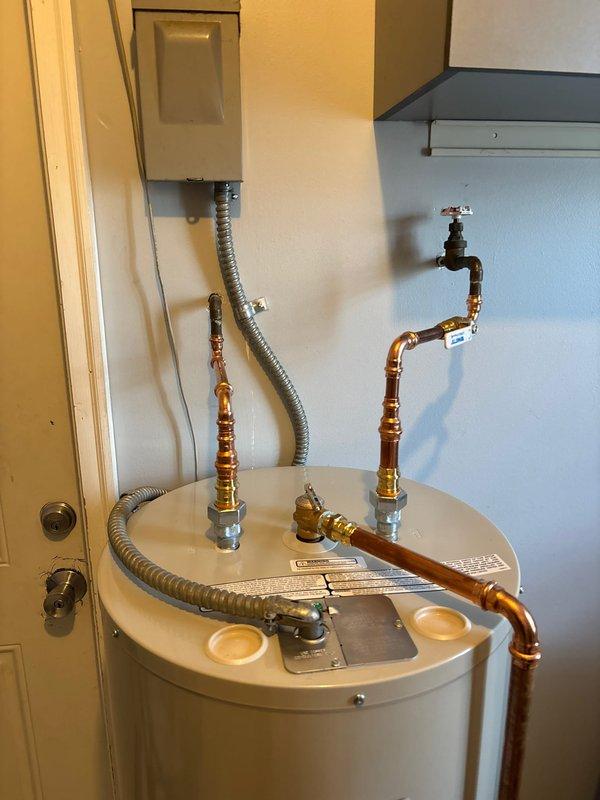 Successfully completed installation of new Bradford White residential water heater in utility room. Properly connected all copper supply and output lines with brass fittings and ensured proper electrical connection via junction box. Installation includes appropriate valving and all connections have been tested for proper operation.