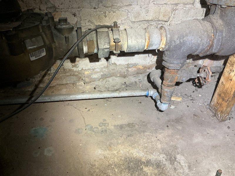 Completed inspection of existing backflow prevention system with significant aging and deterioration. Documented extensive corrosion on main water supply pipes and valve assemblies against concrete wall. Photos taken to support estimate for replacement of deteriorated components and valves.