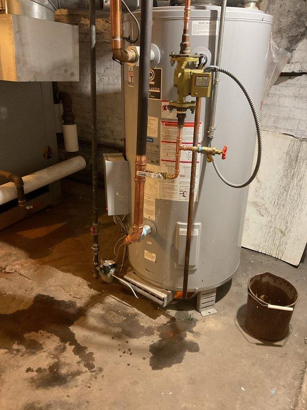 Completed installation of new water heater system in basement utility area, including copper piping connections, gas valve assembly, and all required fittings. System was properly mounted against existing masonry wall with appropriate clearances maintained. Final inspection confirmed no leaks and proper operation of all components.