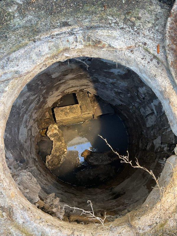 Conducted inspection of toilet system with slow flushing issues as reported. Upon examination, discovered clogged sewer line requiring rodding service. Documented significant deterioration in drainage access point with standing water and debris accumulation. Awaiting authorization from William before proceeding with recommended sewer line rodding to restore proper drainage function.