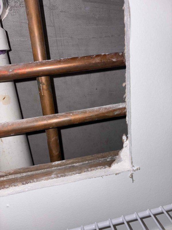 Conducted thorough inspection of exposed copper refrigeration lines showing significant frost accumulation and surface degradation. Provided client with spot repair estimates for addressing refrigerant leakage issues and recommended proper sealing of pipe penetrations through drywall to prevent further deterioration of surrounding materials.