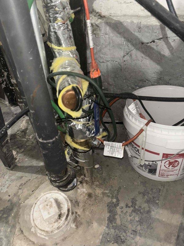 Performed diagnostic assessment of a water main line with active leak reported by customer. Inspection revealed significant corrosion and oxidation on interior pipe walls with visible rust buildup. Located leak source at connection point near water meter assembly. Observed debris accumulation (twigs, leaves) around the meter pit area that required clearing for proper access. System includes copper pipe components and requires yellow insulated pipe section replacement where damage was identified.