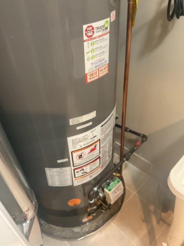 Conducted estimate for replacement of existing Rheem Classic Plus Series water heater with requested tankless unit. Current installation includes copper supply lines, PVC venting system, and associated valves in utility closet. Documented current configuration with photos to facilitate accurate quote for tankless conversion, noting existing connections and space constraints.