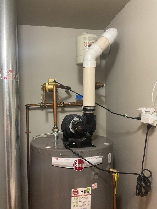 Conducted estimate for replacement of existing Rheem Classic Plus Series water heater with requested tankless unit. Current installation includes copper supply lines, PVC venting system, and associated valves in utility closet. Documented current configuration with photos to facilitate accurate quote for tankless conversion, noting existing connections and space constraints.