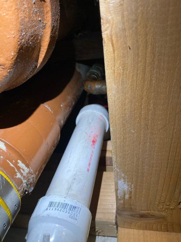 Completed installation of PVC drainage system with copper supply lines in residential area. Properly secured piping through ceiling access point and connected to existing plumbing infrastructure within the wall cavity. All connections were verified and tested for proper function.