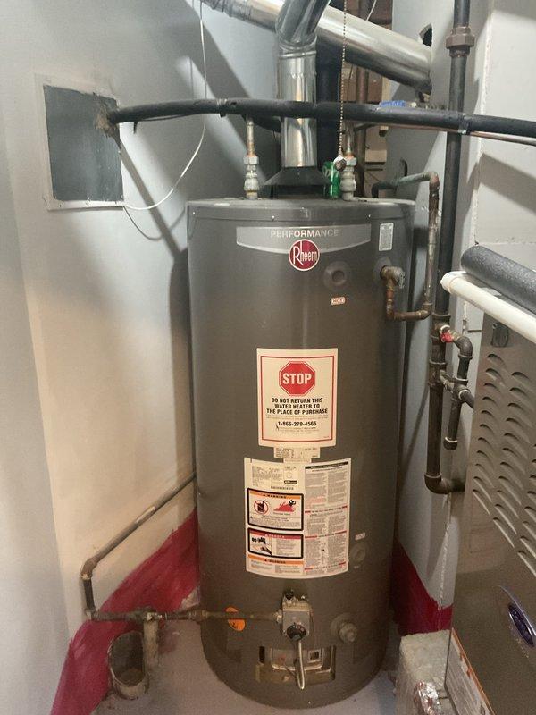 Inspected floor drain backup issue occurring during rainfall. Found drain clog in basement area requiring cleaning service. Also examined existing Rheem Performance water heater (installed 2016) for potential replacement. Provided customer with replacement options and recommendations based on current installation configuration.