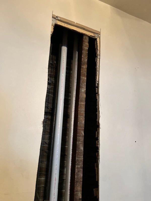 Successfully completed angle stop replacement for second floor toilet. Accessed plumbing through wall opening to reach supply lines. Installed new angle stop to ensure proper water shutoff functionality.