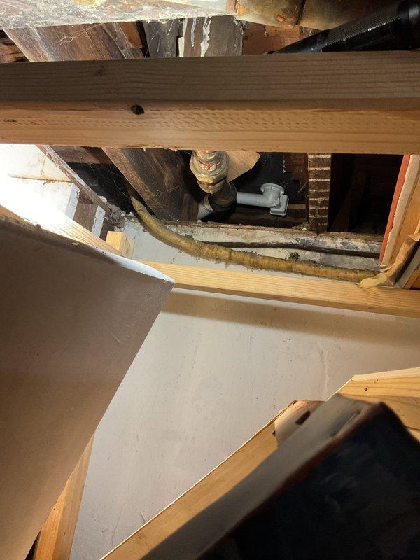 Responded to service call for bathtub drainage issue and toilet instability. Upon inspection of the crawlspace, identified deteriorated wooden structural supports and compromised plumbing connections. Repaired damaged pipe fittings and reinforced floor joists beneath bathroom fixtures to restore proper drainage and stabilize toilet mounting.