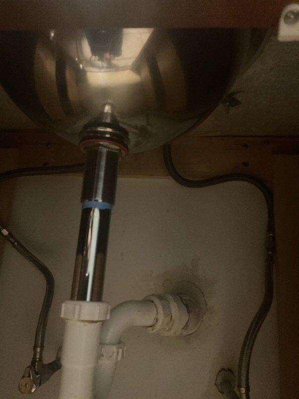 Conducted assessment for replacement of undermount bathroom sink. Existing granite countertop has functional mounting clamps in place. Customer requests contractor to supply new sink. Documented current plumbing configuration including drain assembly and supply lines.